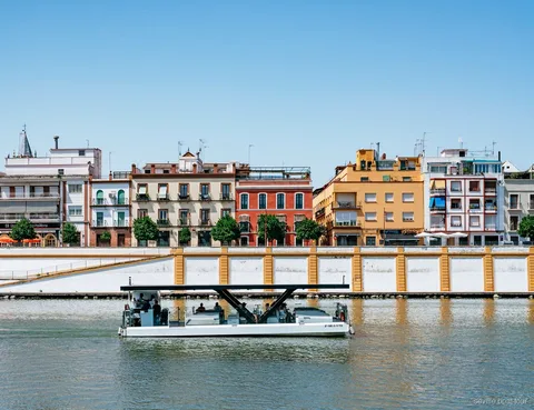 Passengers on the Guadalquivir River Eco Cruise enjoying the Seville skyline